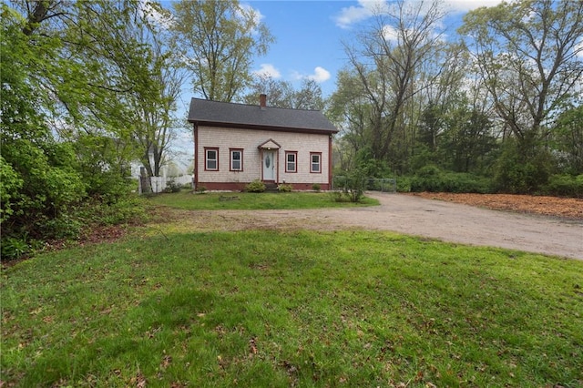 183 Annaquatucket Rd, North Kingstown, RI 02852 - view of front facade with driveway, a front yard, and a chimney