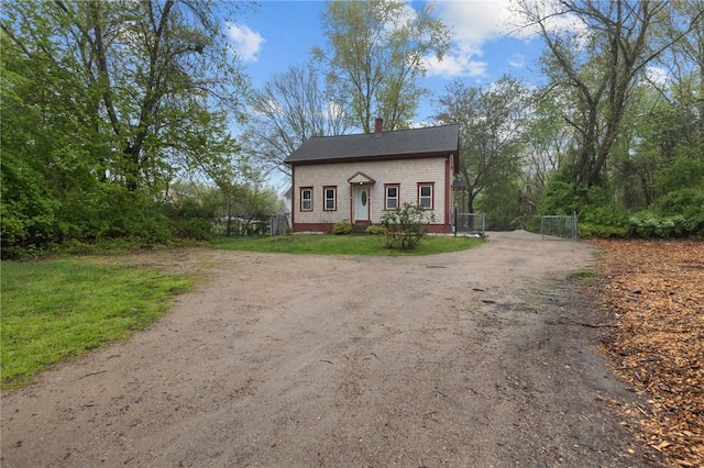 183 Annaquatucket Rd, North Kingstown, RI 02852 - view of front facade featuring driveway, a gate, a chimney, and fence