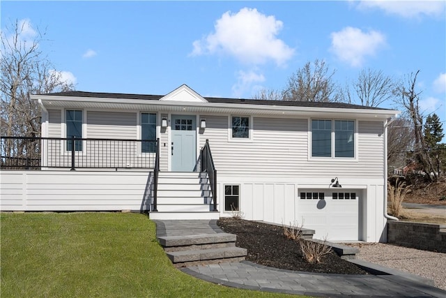 9 Stedman Rd, South Kingstown, RI 02879 - view of front of house featuring a garage, a front yard, and a porch