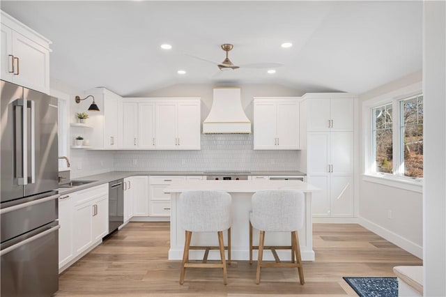 9 Stedman Rd, South Kingstown, RI 02879 - kitchen featuring appliances with stainless steel finishes, custom range hood, open shelves, ceiling fan, and a sink