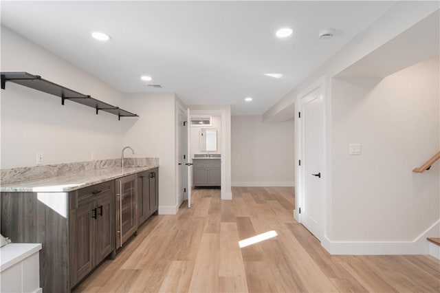 9 Stedman Rd, South Kingstown, RI 02879 - kitchen with beverage cooler, light wood-style floors, open shelves, dark brown cabinets, and recessed lighting