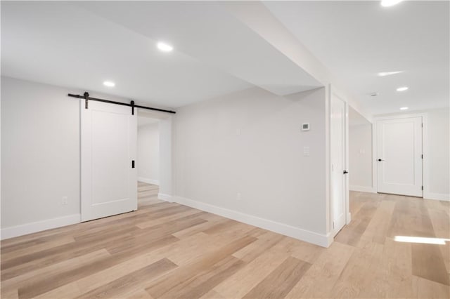 9 Stedman Rd, South Kingstown, RI 02879 - below grade area featuring a barn door, light wood-type flooring, and recessed lighting