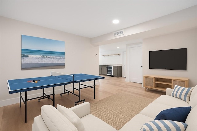 9 Stedman Rd, South Kingstown, RI 02879 - recreation room with wine cooler, light wood finished floors, bar area, recessed lighting, and a water view