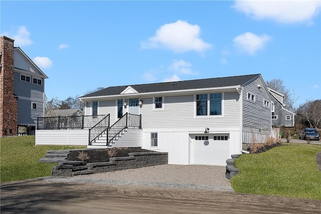 9 Stedman Rd, South Kingstown, RI 02879 - view of front of property featuring a garage, a front lawn, and gravel driveway