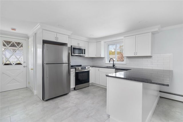 kitchen with stainless steel appliances, a peninsula, white cabinets, ornamental molding, and decorative backsplash