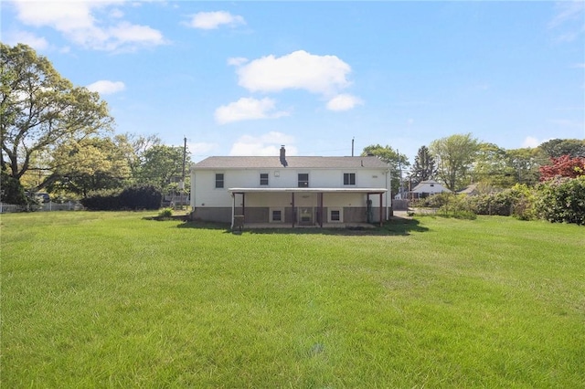 rear view of house with a yard