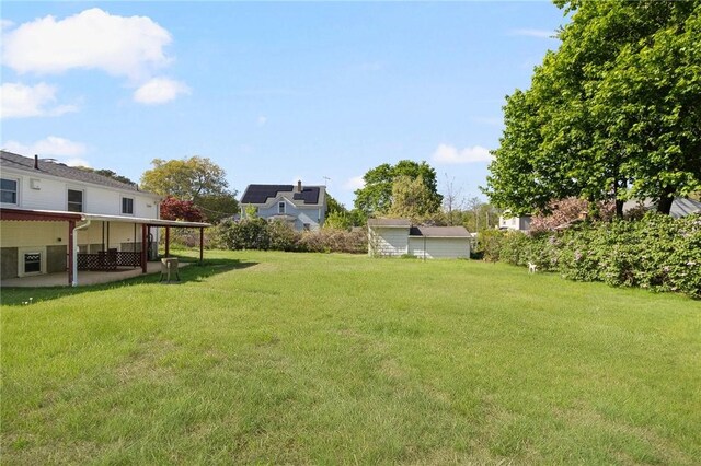 view of grassy yard with a patio