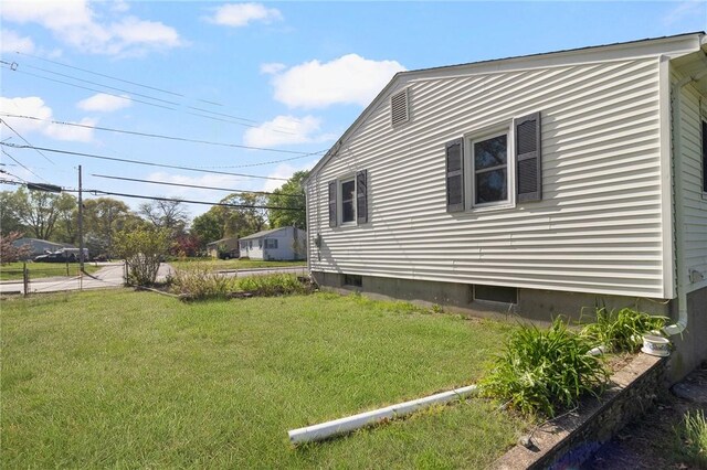 view of side of home featuring a yard