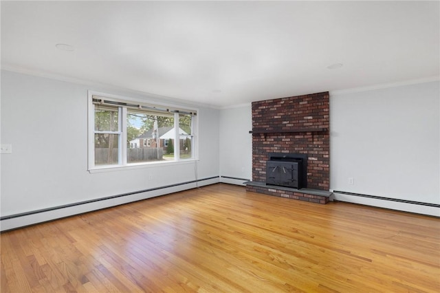 unfurnished living room featuring wood finished floors, crown molding, a baseboard radiator, and a brick fireplace