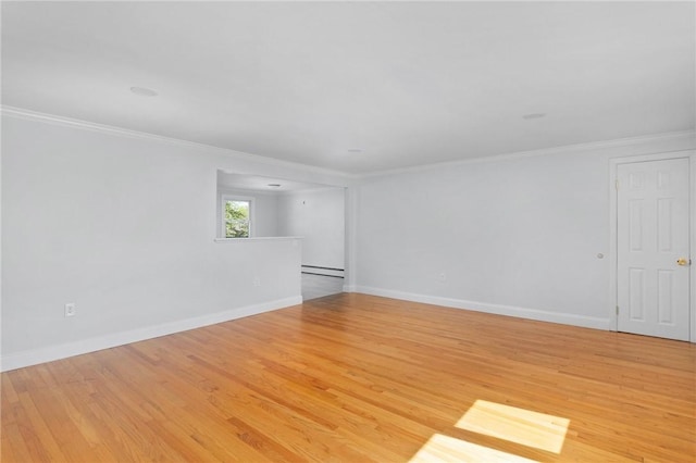 unfurnished room featuring baseboard heating, crown molding, light wood-style floors, and baseboards