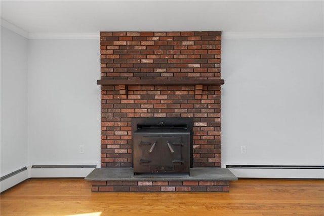 detailed view of ornamental molding, wood finished floors, and baseboard heating