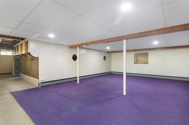 finished below grade area with carpet flooring, a paneled ceiling, recessed lighting, and baseboard heating