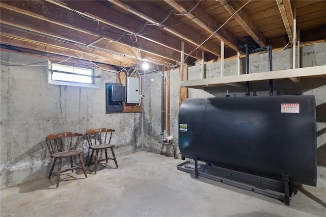 below grade area with oil tank and electric panel