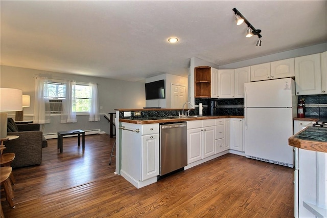 kitchen featuring freestanding refrigerator, stainless steel dishwasher, open floor plan, a peninsula, and white cabinets