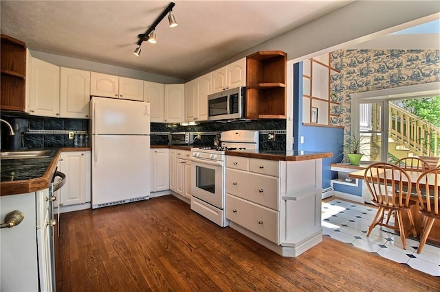 kitchen with open shelves, white appliances, a sink, white cabinetry, and backsplash