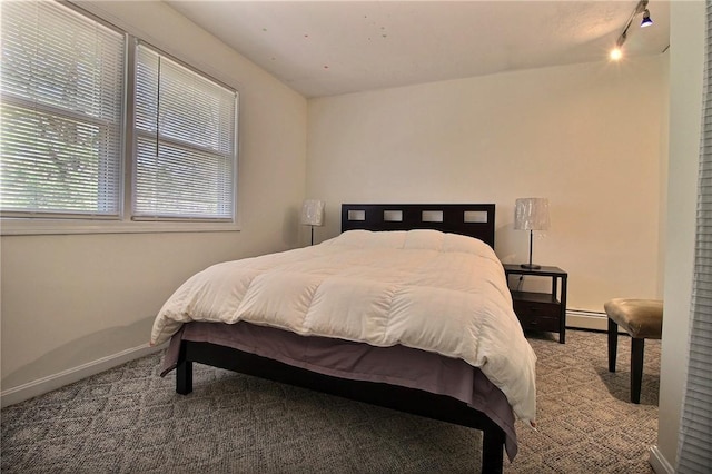 bedroom featuring carpet, a baseboard radiator, and baseboards