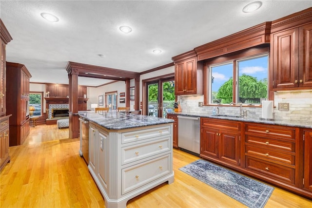 831 N Quidnessett Rd, North Kingstown, RI 02852 - kitchen with stainless steel dishwasher, crown molding, light wood-type flooring, tasteful backsplash, and stone countertops
