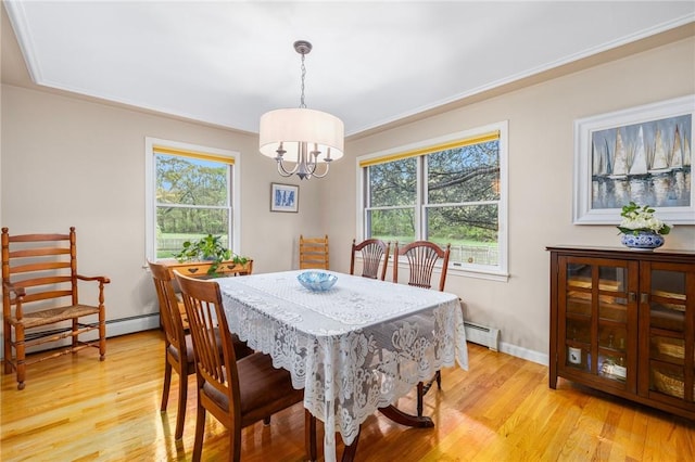 831 N Quidnessett Rd, North Kingstown, RI 02852 - dining area with a baseboard radiator, plenty of natural light, and light wood finished floors