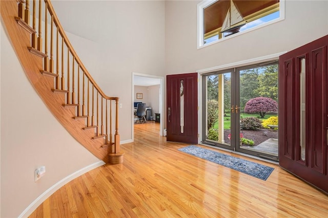 831 N Quidnessett Rd, North Kingstown, RI 02852 - entryway with wood finished floors, a high ceiling, stairway, and baseboards