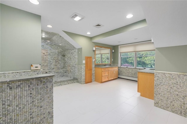 831 N Quidnessett Rd, North Kingstown, RI 02852 - bathroom with walk in shower, tile walls, vanity, baseboard heating, and tile patterned floors