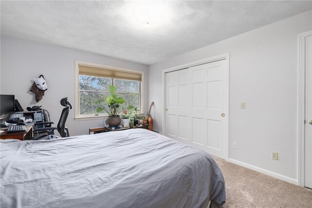 831 N Quidnessett Rd, North Kingstown, RI 02852 - bedroom with carpet flooring, baseboards, a closet, and a textured ceiling