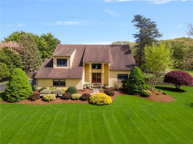 831 N Quidnessett Rd, North Kingstown, RI 02852 - view of front facade featuring a front yard, a chimney, and roof with shingles