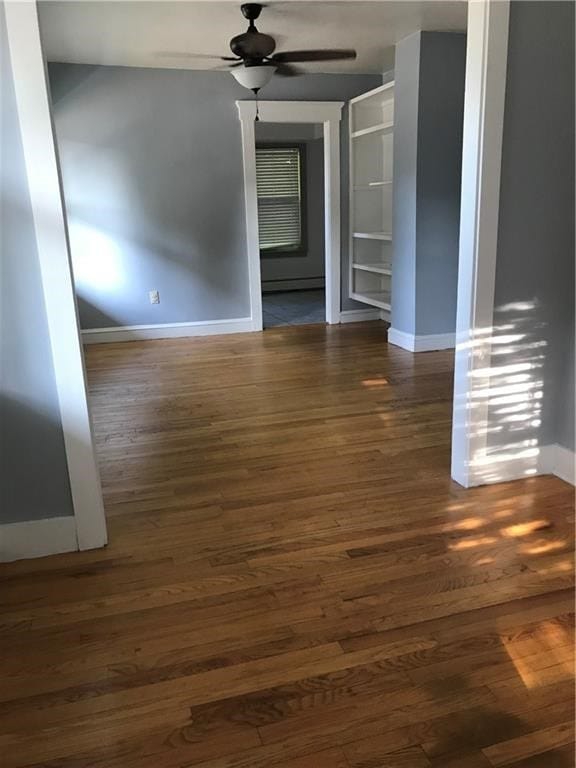 16 Gough Ave, West Warwick, RI 02893 - spare room with baseboards, ceiling fan, wood finished floors, and a baseboard heating unit