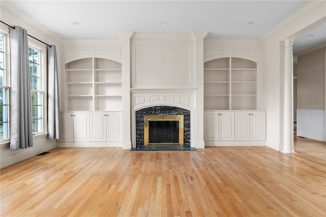 38 Miss Fry Dr, East Greenwich, RI 02818 - unfurnished living room featuring healthy amount of natural light, built in features, light wood finished floors, and crown molding