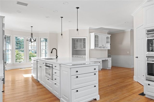 38 Miss Fry Dr, East Greenwich, RI 02818 - kitchen featuring a sink, ornamental molding, light wood-type flooring, white cabinets, and recessed lighting