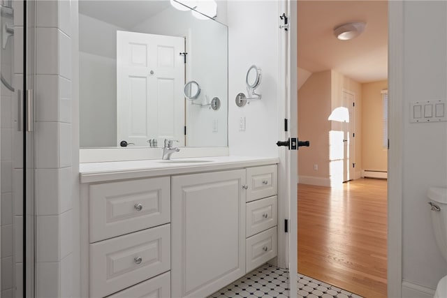38 Miss Fry Dr, East Greenwich, RI 02818 - bathroom with a baseboard heating unit, vanity, tile patterned floors, toilet, and baseboards