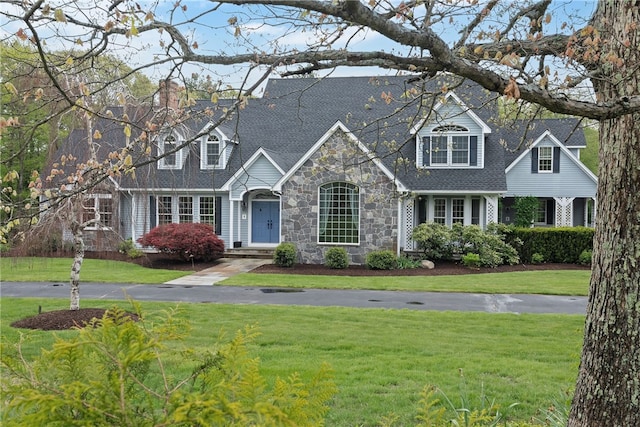 38 Miss Fry Dr, East Greenwich, RI 02818 - cape cod house featuring stone siding, a front lawn, and roof with shingles