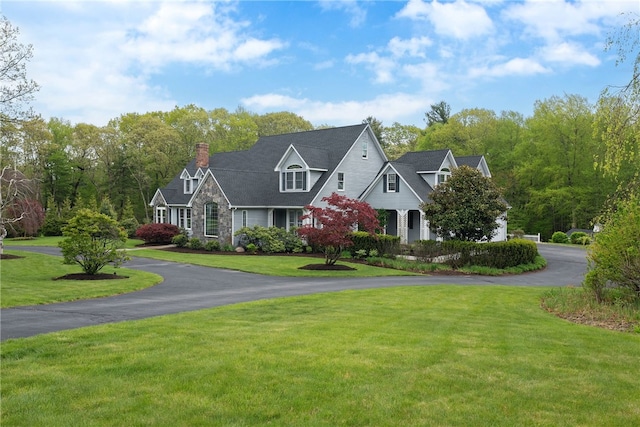 38 Miss Fry Dr, East Greenwich, RI 02818 - view of front of home with a chimney, a front yard, stone siding, and driveway