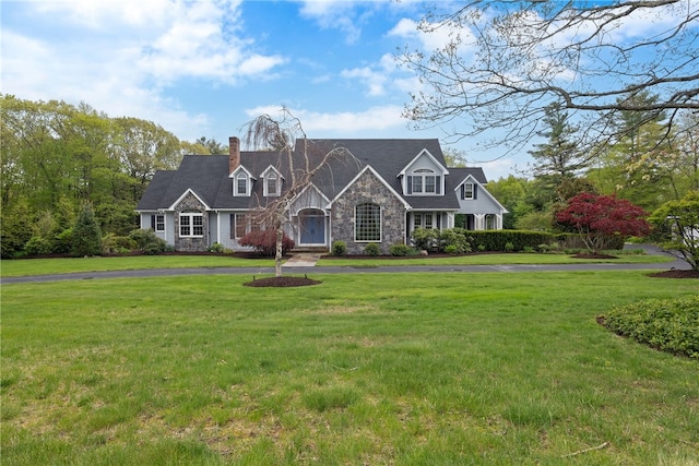 38 Miss Fry Dr, East Greenwich, RI 02818 - view of front of house featuring stone siding, a chimney, and a front yard