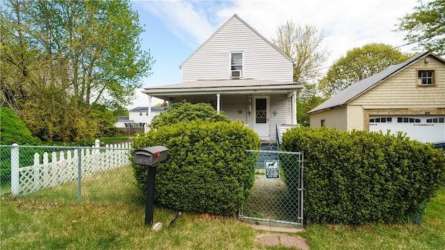 view of front of home with a detached garage, covered porch, a gate, and an outdoor structure
