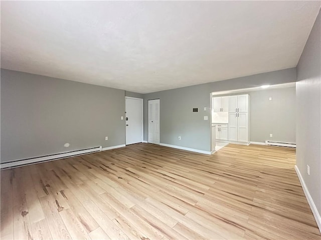 300 Smithfield Rd Unit B3-18, North Providence, RI 02904 - unfurnished living room with baseboard heating, light wood-style flooring, and baseboards