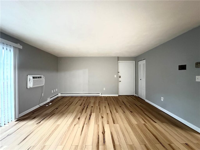 300 Smithfield Rd Unit B3-18, North Providence, RI 02904 - unfurnished living room with a wall mounted air conditioner, wood finished floors, and baseboards