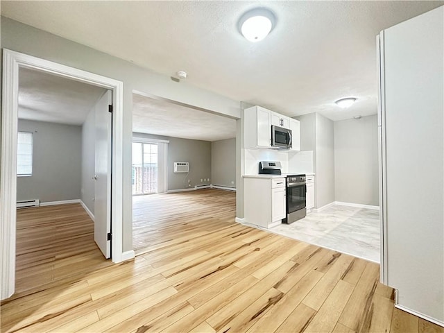 300 Smithfield Rd Unit B3-18, North Providence, RI 02904 - kitchen featuring appliances with stainless steel finishes, light wood-style floors, white cabinetry, a baseboard radiator, and baseboards