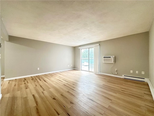 300 Smithfield Rd Unit B3-18, North Providence, RI 02904 - unfurnished living room with a baseboard radiator, light wood-style flooring, a wall mounted air conditioner, baseboards, and a textured ceiling