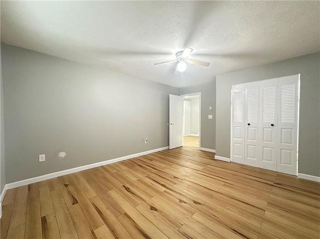 300 Smithfield Rd Unit B3-18, North Providence, RI 02904 - unfurnished bedroom with light wood finished floors, baseboards, a closet, ceiling fan, and a textured ceiling