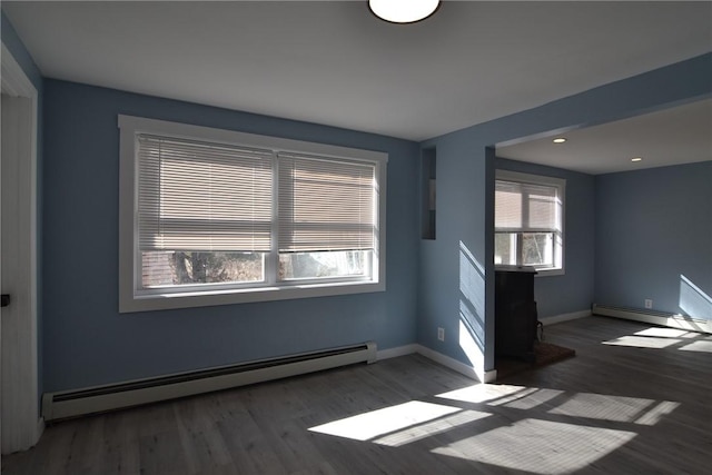 115 Sherman Farm Rd, Burrillville, RI 02830 - spare room featuring a baseboard heating unit, wood finished floors, and baseboards