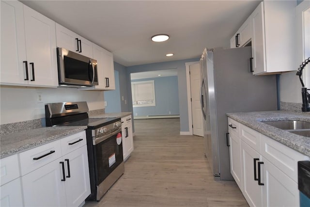 115 Sherman Farm Rd, Burrillville, RI 02830 - kitchen featuring appliances with stainless steel finishes, white cabinetry, light wood-style floors, recessed lighting, and light stone countertops