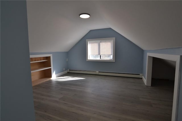 115 Sherman Farm Rd, Burrillville, RI 02830 - bonus room with a baseboard heating unit, wood finished floors, vaulted ceiling, baseboards, and built in features