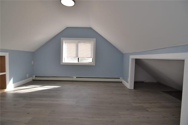 115 Sherman Farm Rd, Burrillville, RI 02830 - bonus room featuring a baseboard radiator, lofted ceiling, wood finished floors, and baseboards