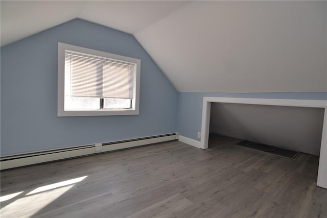 115 Sherman Farm Rd, Burrillville, RI 02830 - additional living space featuring a baseboard heating unit, wood finished floors, lofted ceiling, and baseboards