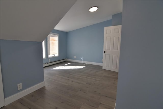 115 Sherman Farm Rd, Burrillville, RI 02830 - additional living space with baseboard heating, lofted ceiling, baseboards, and wood finished floors