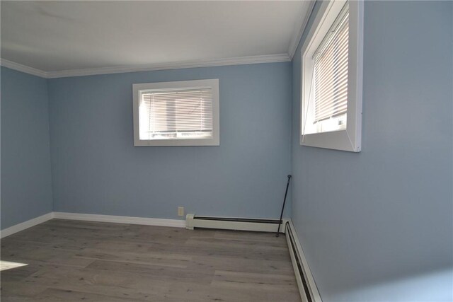 115 Sherman Farm Rd, Burrillville, RI 02830 - unfurnished room featuring a baseboard radiator, crown molding, wood finished floors, and baseboards