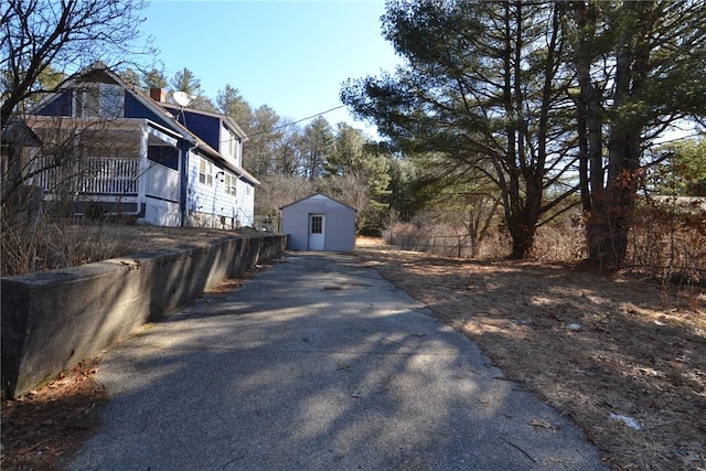 115 Sherman Farm Rd, Burrillville, RI 02830 - view of property exterior with driveway, an outbuilding, a storage unit, and a chimney