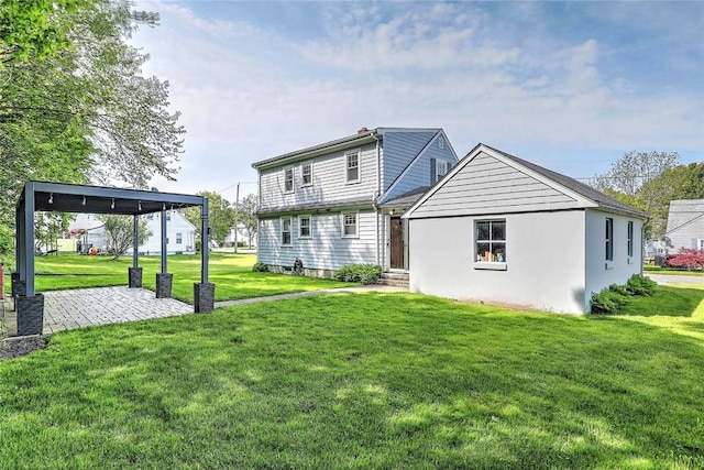 14 Manchester St, Bristol, RI 02809 - back of property featuring a yard and a patio area