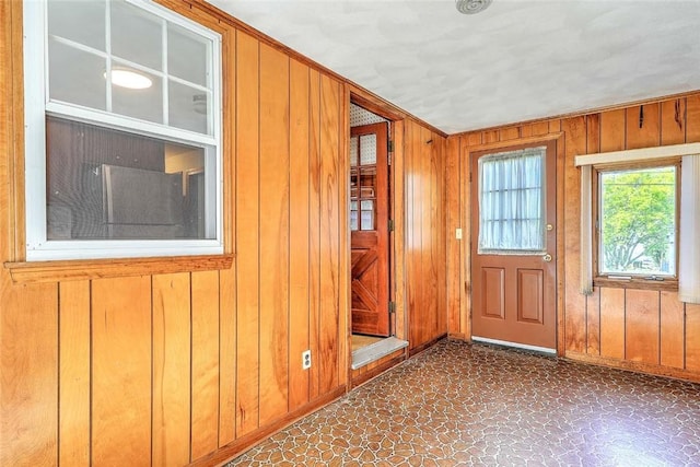 14 Manchester St, Bristol, RI 02809 - doorway to outside with tile patterned floors, wooden walls, and baseboards