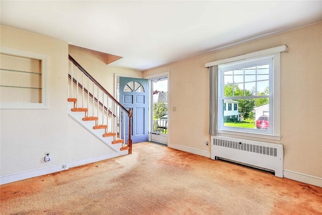 14 Manchester St, Bristol, RI 02809 - carpeted entryway with radiator, stairs, and baseboards